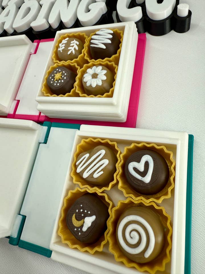 Book full of chocolate clickers for wholesale by Eastbrook Trading