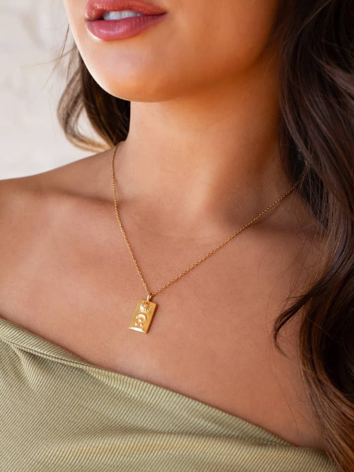 Luxe Gold Necklace with Sun, Moon & Stars Pendant for wholesale by Panache Apparel Co.