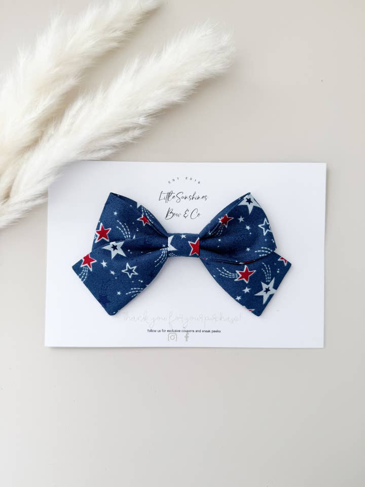 Blue & Red Stars 4th of July Pinwheel Hair Bow for wholesale by Little Sunshines Bow & Co