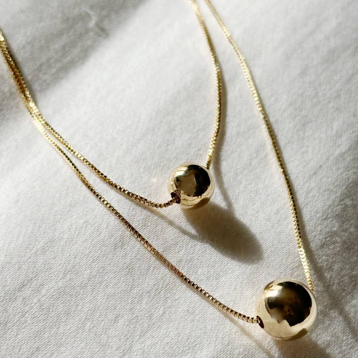 Double Layer Golden Sphere Necklace for wholesale by Lily Max Jewelry