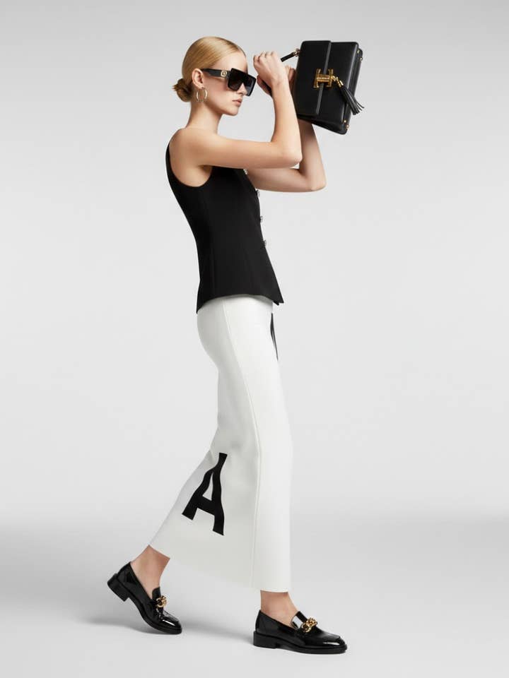 Maßgeschneidertes schwarzes Weste-Top mit Kristallknöpfen und Schößchen-Saum • BYMANYC ® New York für den Großhandel von BYMANYC NEW YORK