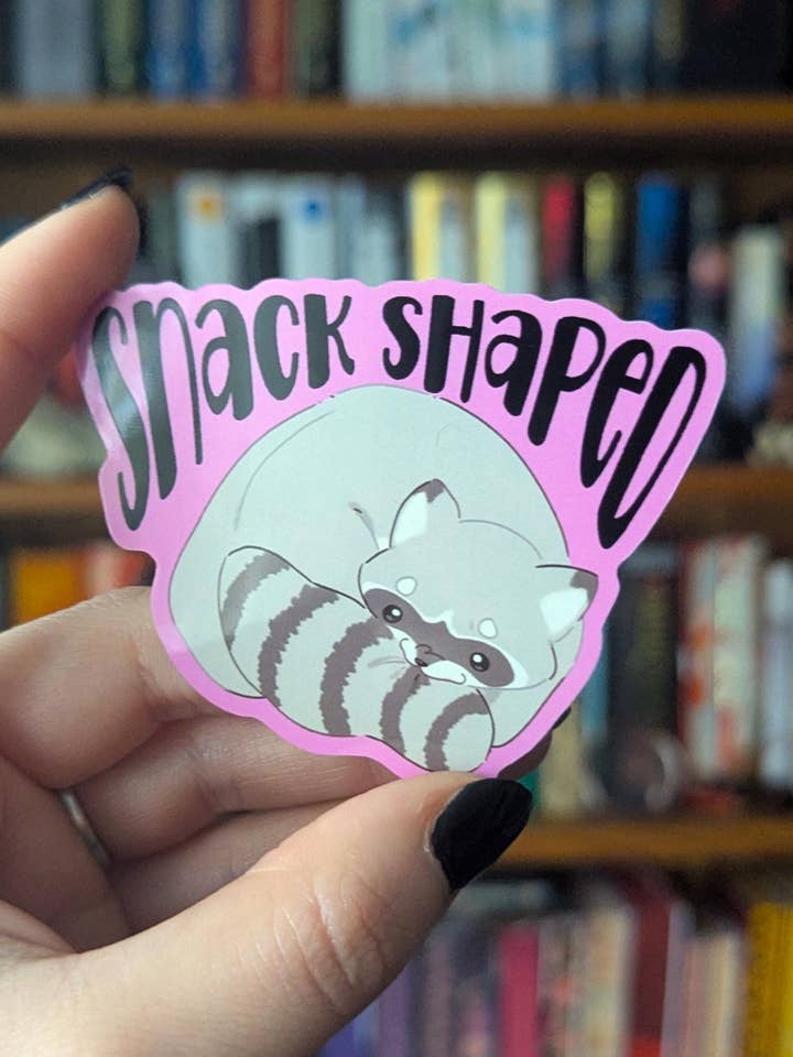 Snack shaped chaotic raccoon vinyl sticker for wholesale by Geek and Artsy