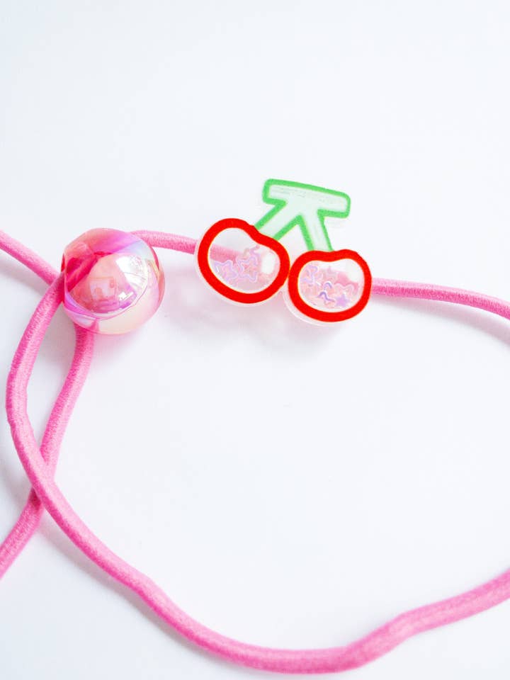 Elastici per capelli con charm riempiti di coriandoli per la vendita all'ingrosso da parte di Eggy Cakes