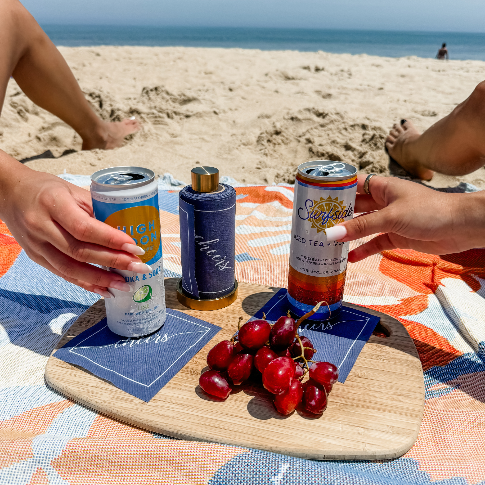 Table Theory (Formerly Toasting with Tara) – wholesale Disposable napkin – Cotton Cocktail Napkin Roll: Mystic Blue - White "Cheers"1