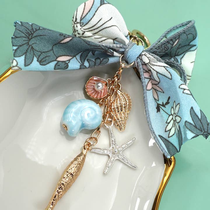 Gold BAG CHARM-OCEAN PORCELAIN FISH SEA SHELL STARFISH | 80K066 for wholesale on Faire2