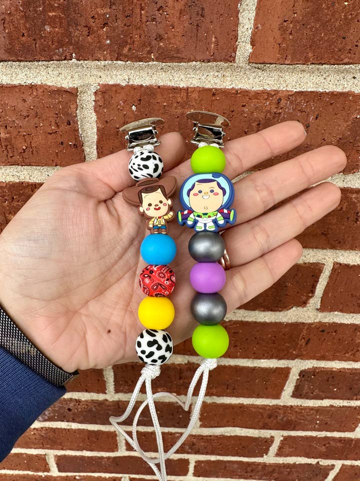 Cowboy + Spaceboy Pacifier Clip for wholesale by Ridge & Co Teething Shop LLC