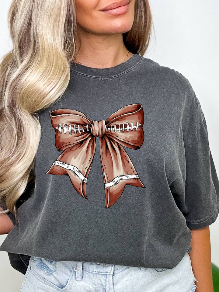 Football Coquette Bow on Pepper Comfort Colors Tee for wholesale by MVP Tee Shop Wholesale