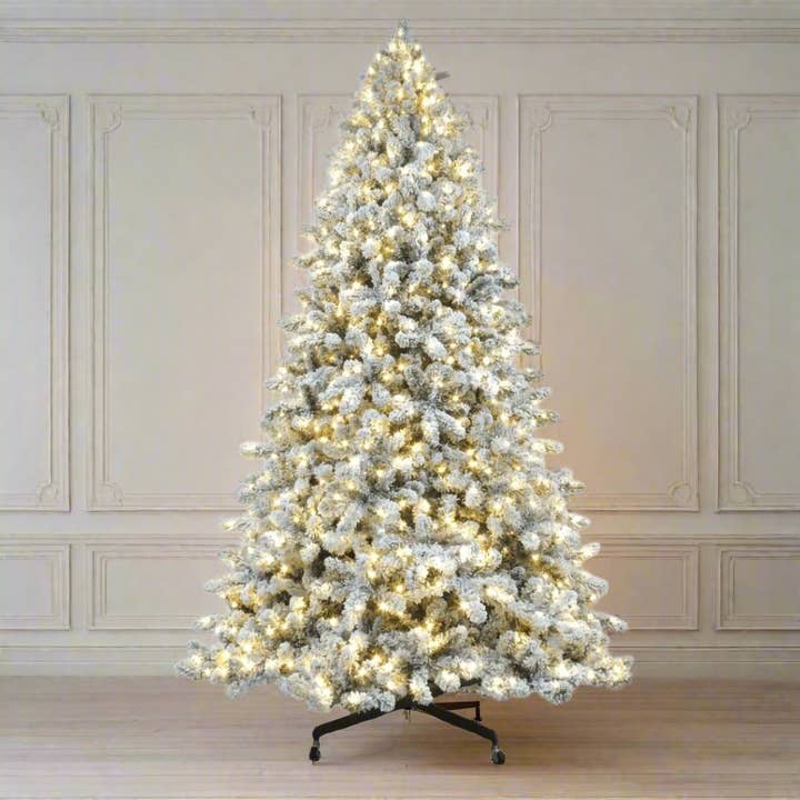 Joy By 8.5' Flocked Christmas tree with 900 Warm White LED Lights for wholesale by Joy By