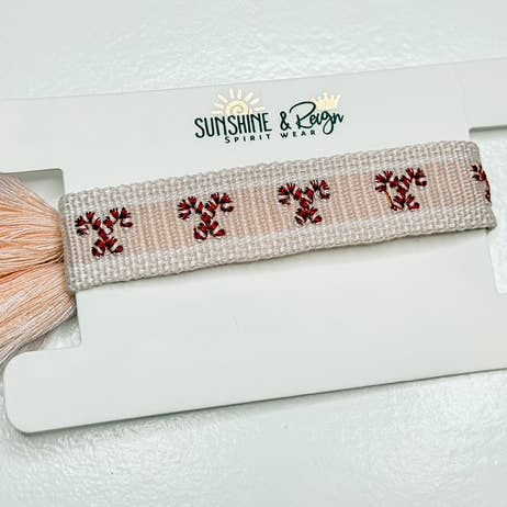 Braccialetto con nappina a bastoncino di zucchero per la vendita all'ingrosso da parte di Sunshine and Reign Clothing