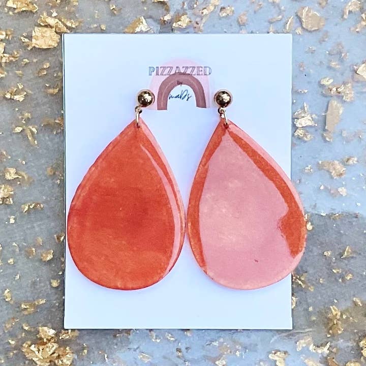 Orange feather dangles for wholesale by Pizzazzed by Mads