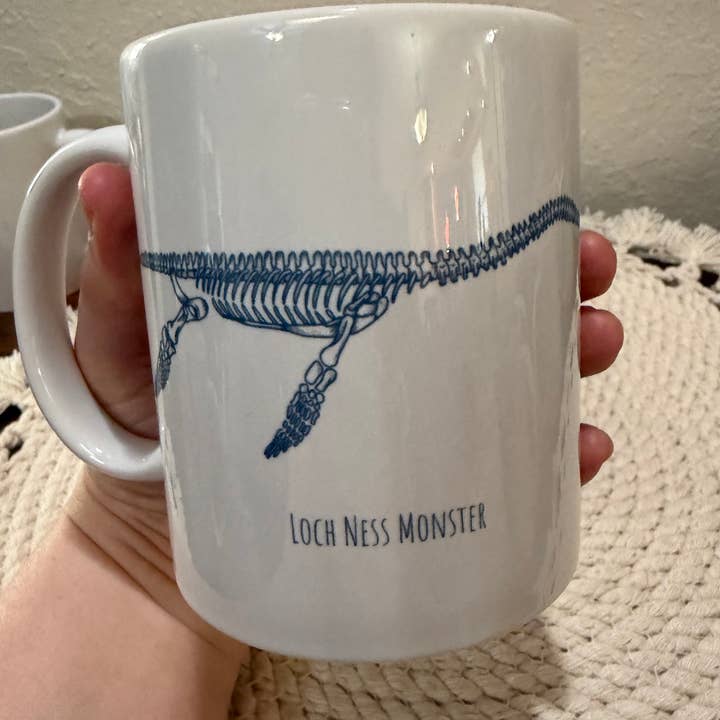 Loch Ness Monster Skeleton Illustration Ceramic Mug for wholesale by Cryptic Paper Co.