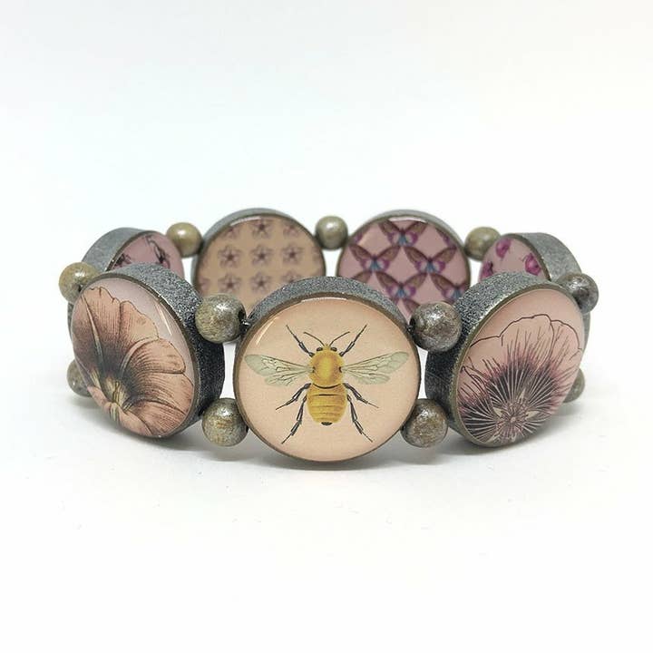 „Ronde houten armband met bijen- en co-motieven in roze” voor wholesale door Escapulario