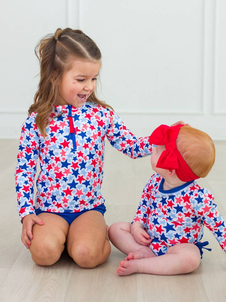 Multi Color Girls Shimmer Star-Spangled Long Sleeve Zipper Rash Guard 2-Piece Swimsuit with Signature Rear Ruffles
for wholesale on Faire