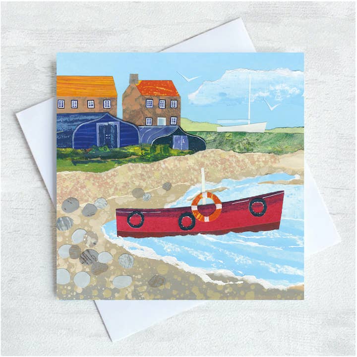 Red boat on Lindisfarne Coastal Seaside Greetings Card for wholesale by Joanne Wishart