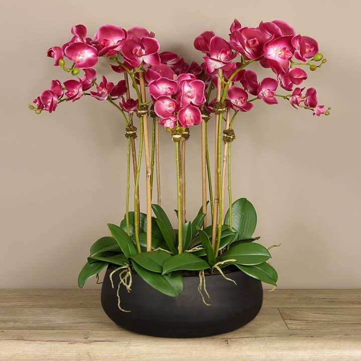 Artificial floral arrangement centerpiece with pink orchids in black planter for wholesale by Vivian Rose LLC