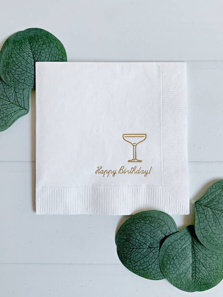 Happy Birthday Coup Cocktail Napkins - Gold on White for wholesale by EnFete, LLC