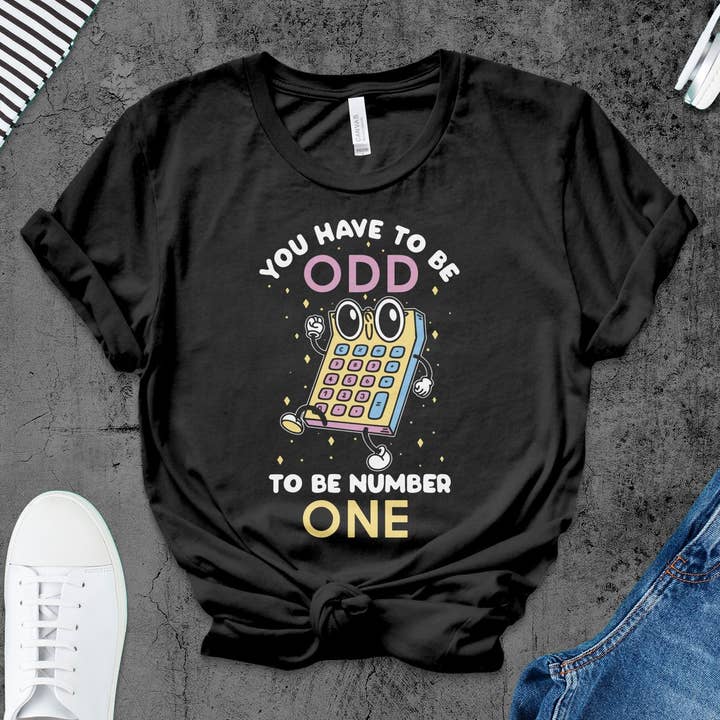 Quirky Odd One Cartoon Calculator T-Shirt, Unique Graphic Tee, Math Geek Humor Shirt, Funny Nerd Apparel, Unisex Tee Gift for wholesale by FreakyTeeFactory