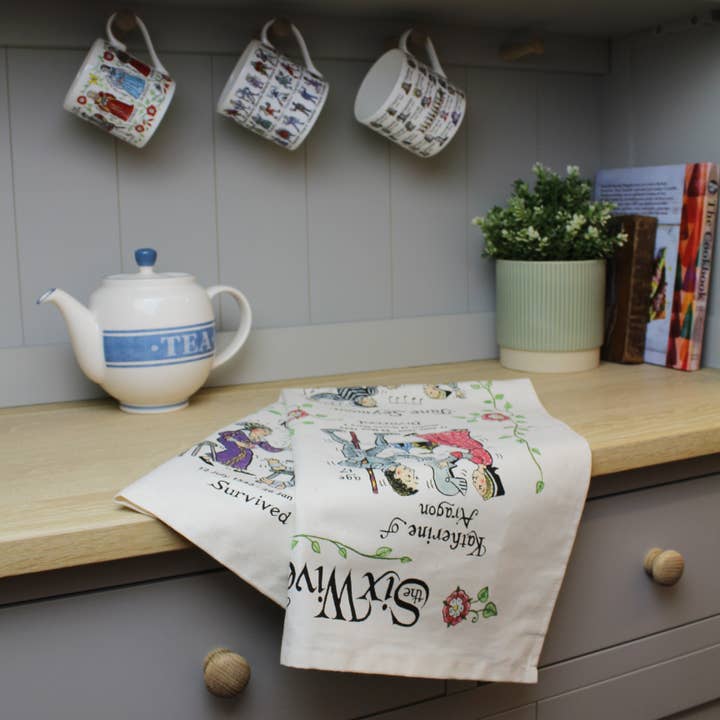 Six Wives of Henry VII Tea Towel for wholesale by mclaggan+co