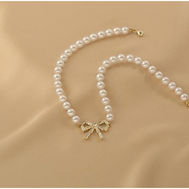 Gold Ladies Lux Fake Pearl Bowknot Necklace SKAJ015 for wholesale on Faire8