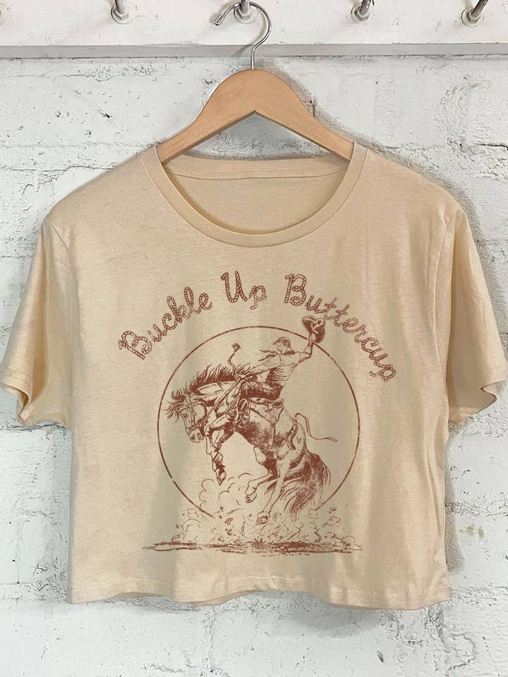 BUCKLE UP BUTTERCUP RODEO COWBOY GRAPHIC SHORT CROP TOP for wholesale by Rustee Clothing