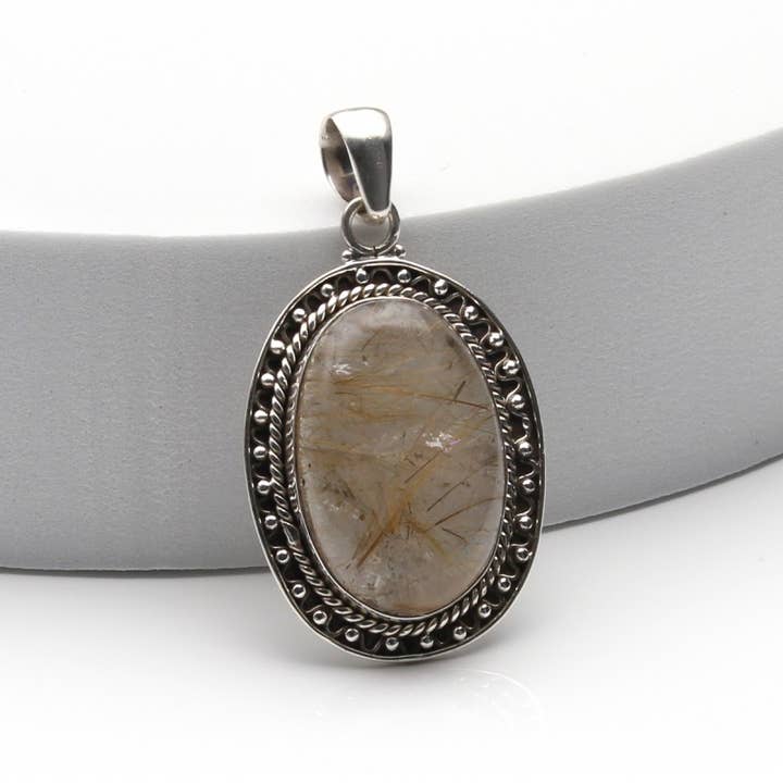 Rutilated quartz in silver, oval pendant for wholesale by UniArt