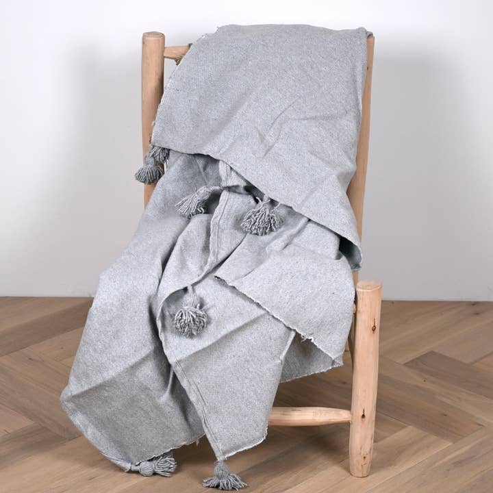 Light gray Moroccan pompom throw for wholesale by Bohome Living