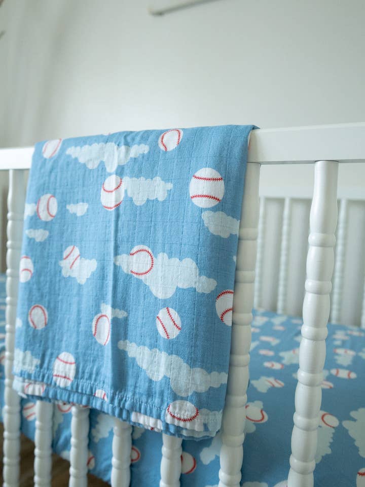 Baseballs in the Sky Organic Bamboo Cotton Muslin Swaddle Blanket for wholesale by Cradle Comforts Co.