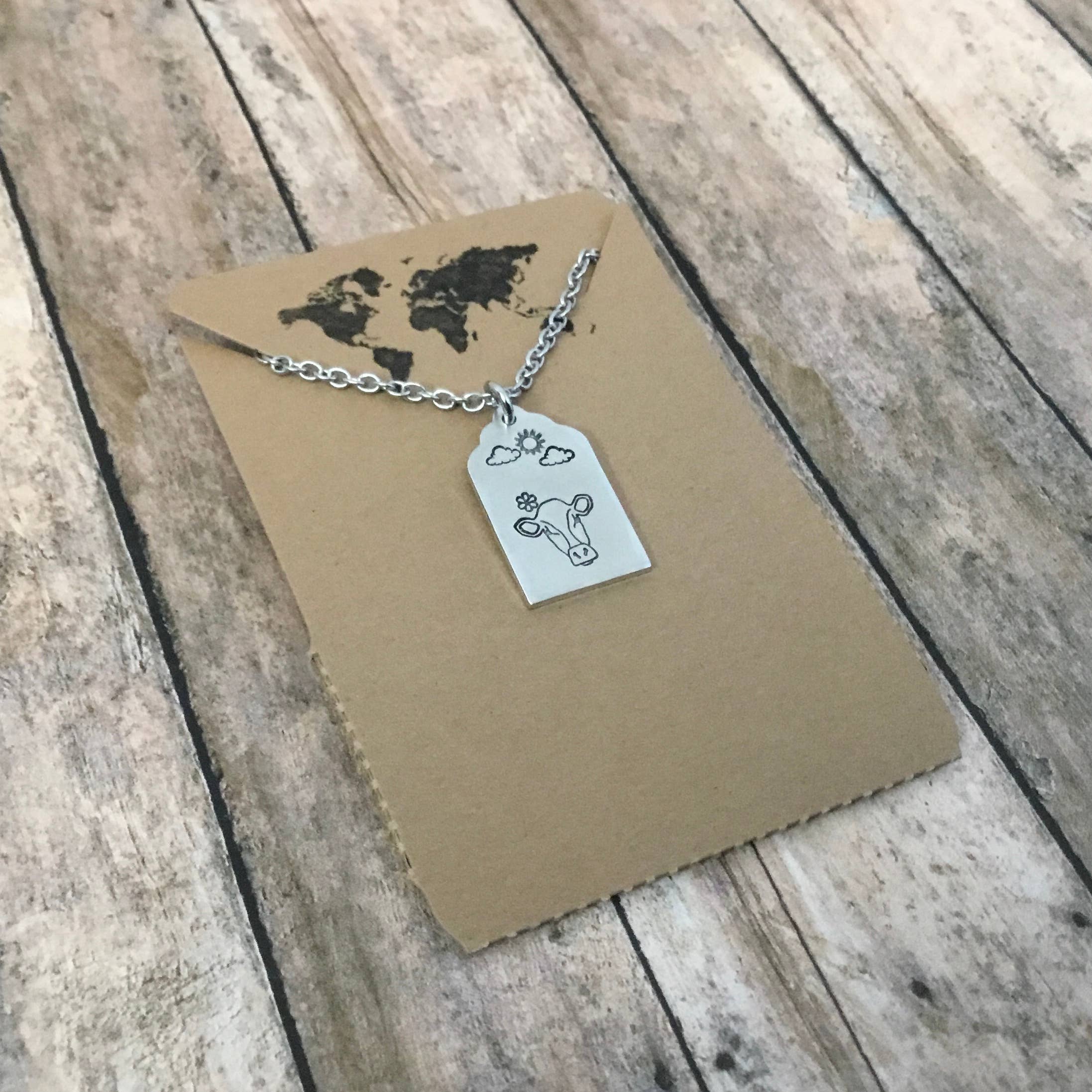 Jamie Haley Designs - Wholesale Pendant/Charm Necklace - Cow on cloudy day, cattle ear tag style pendant1