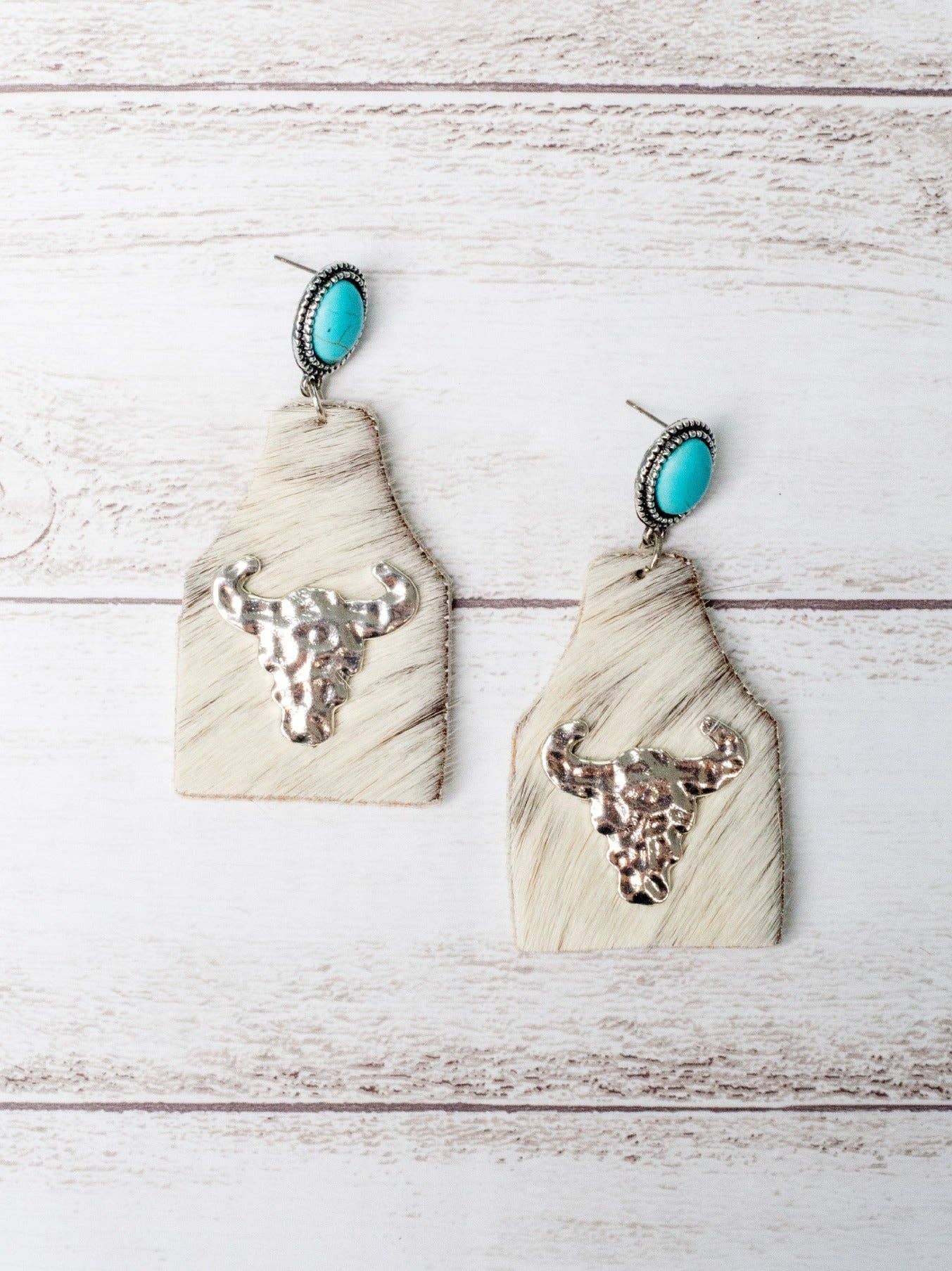 TAKE A NUMBER COWBOY WHITE COWHIDE SILVER COWSKULL STUD EARRINGS for wholesale on Faire1