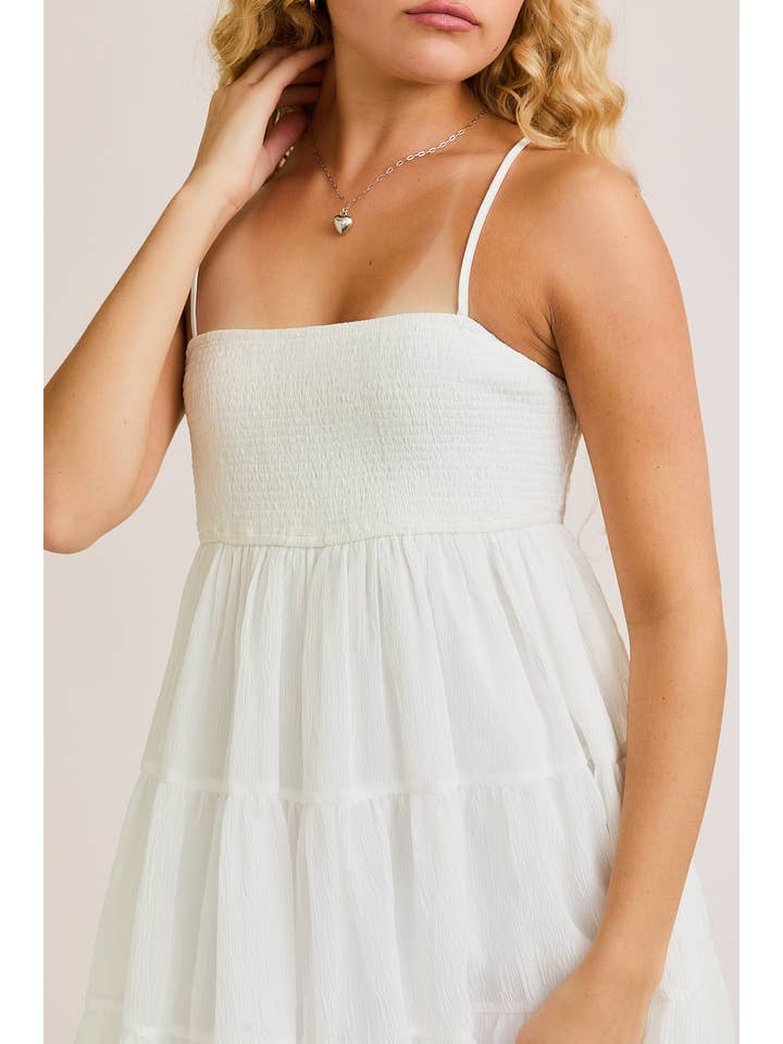 White SMOCKED TIERED MINI DRESS for wholesale on Faire