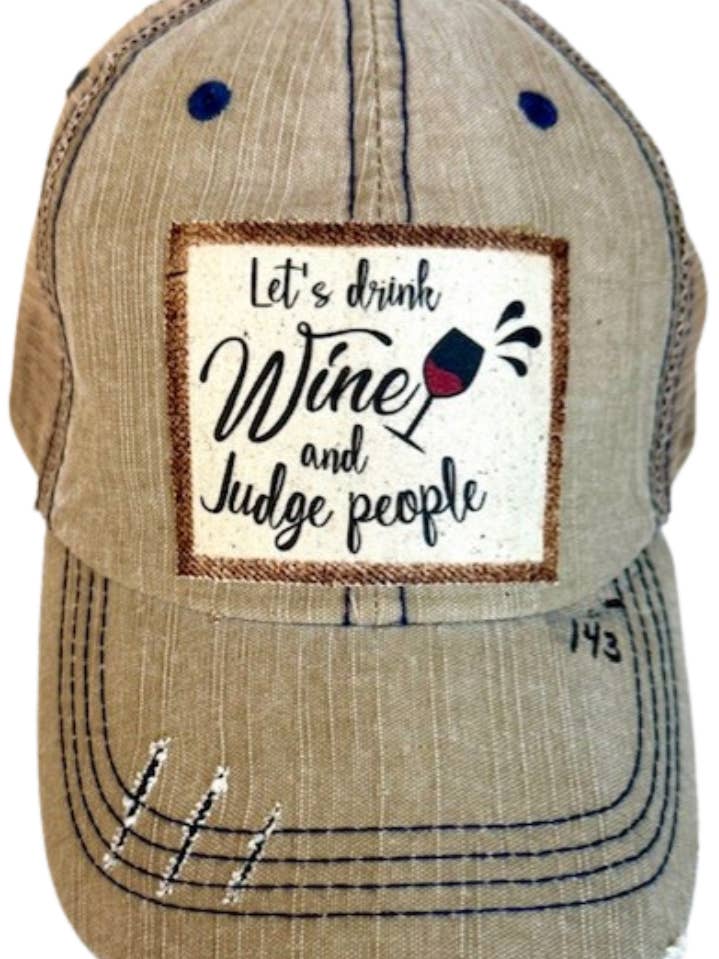(143) "LET'S DRINK WINE AND JUDGE" DISTRESSED TRUCKER HAT for wholesale by Jana's Flannels