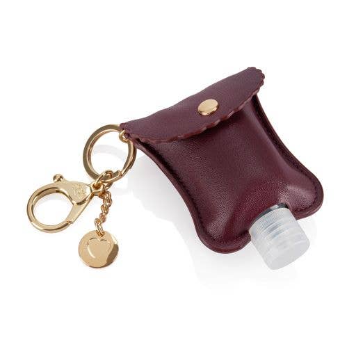 Small hand sanitizer bottle to go in woman's purse. Girl using portable  sanitiser in bag, when going on commute, for disinfecting hands as COVID  prevention. Stock Photo | Adobe Stock