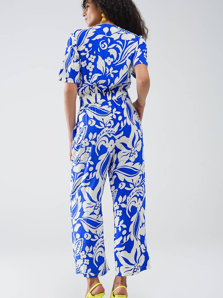 Blå Blå jumpsuit med kort ärm, knytbar nyckelhåls-urringning och blommönster för wholesale på Faire2