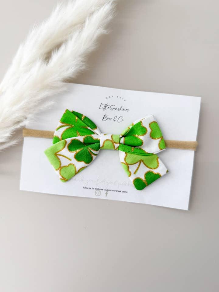 White & Gold Sparkle Clovers St Patricks Day Pinwheel Bow for wholesale by Little Sunshines Bow & Co