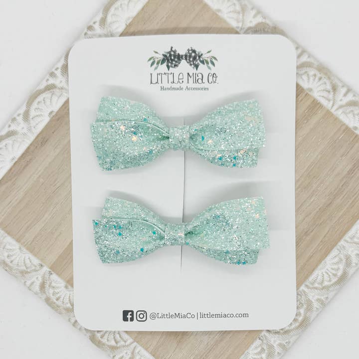 Fermagli Lou Piggy con Glitter Verde Teal per la vendita all'ingrosso da parte di Little Mia Co.