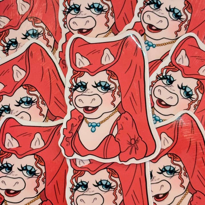 „Held og lykke babe!“ Piggy klistermærke for engroshandel hos Okay Casanova Studios LLC