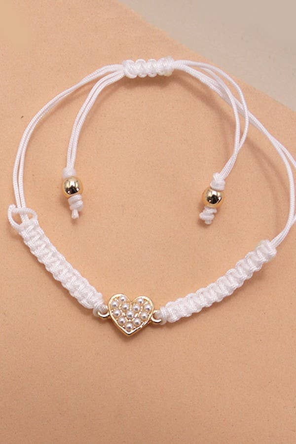 JOSSLYN by wall to wall - Wholesale Charm/Dangle Bracelet - ADJUSTABLE ROPE BAND PEARL HEART BOW BRACELET | 80B1612