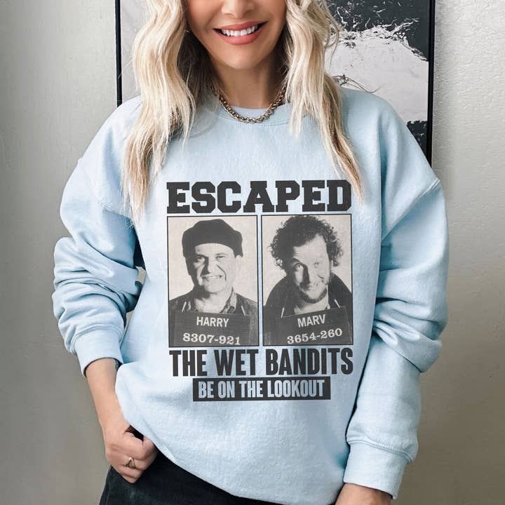 NVC Ecommerce LLC - Wholesale Graphic Sweatshirt - Women's - Retro Home Alone Escaped Mugshots The Wet Bandits Sweatshirt