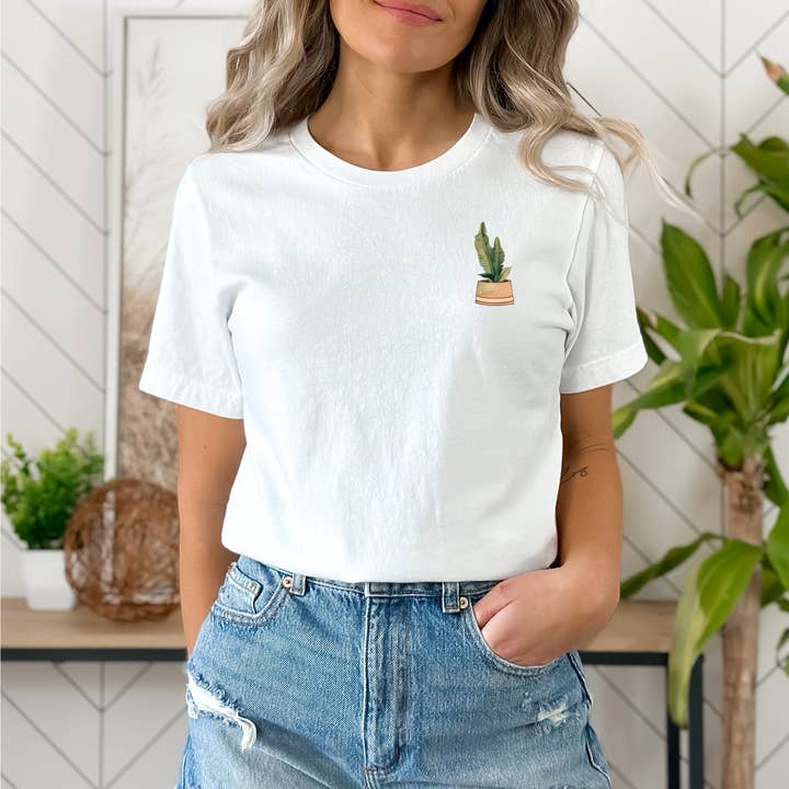 Bananblad i solbrun plantekasse grafisk tee, unisex Bella+lærred for engroshandel hos Snow Cactus Station