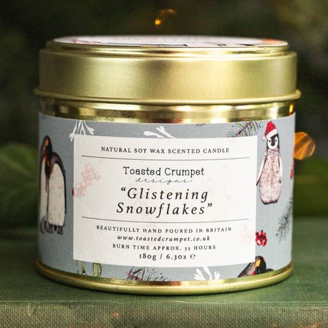 Glistening Snowflakes Candle Matt Gold Tin (Penguins) for wholesale by Toasted Crumpet