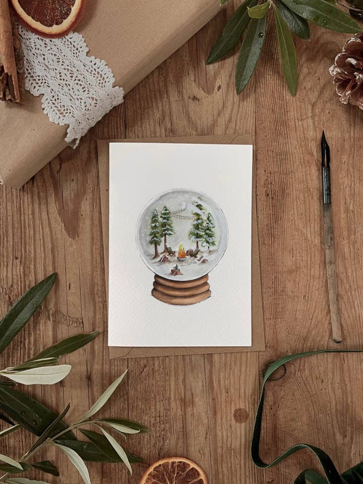 A Winter Celebration Snowglobe Christmas Card for wholesale by Brooke Marie