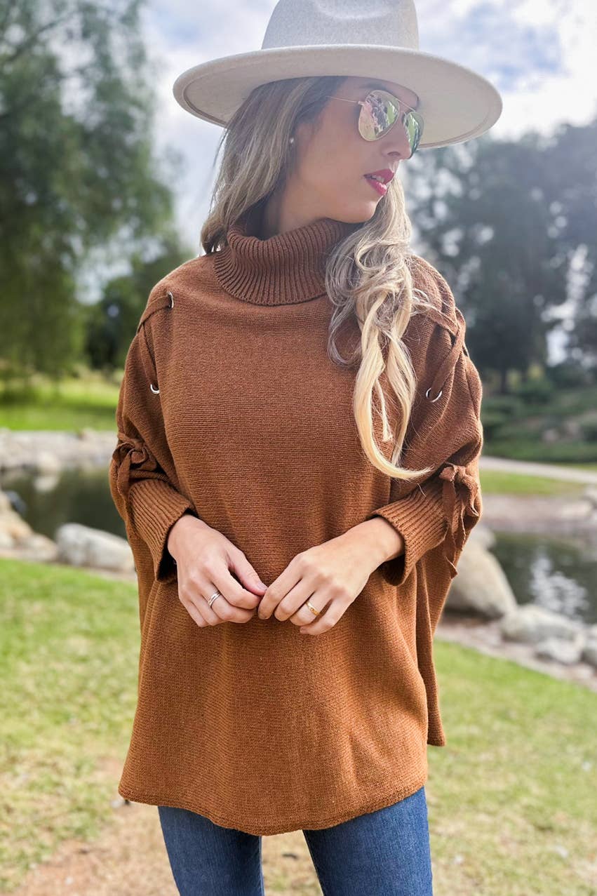 Cognac Poncho in maglia a collo alto con maniche stringate color cognac in vendita all'ingrosso su Faire4