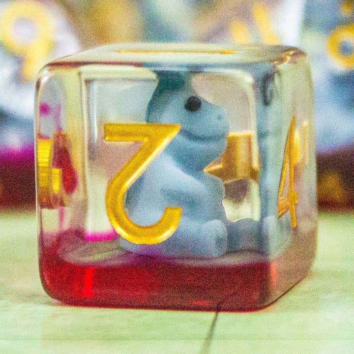 Inclusion Blue Dinosaurs Dice Set for wholesale by Mystery Dice Goblin