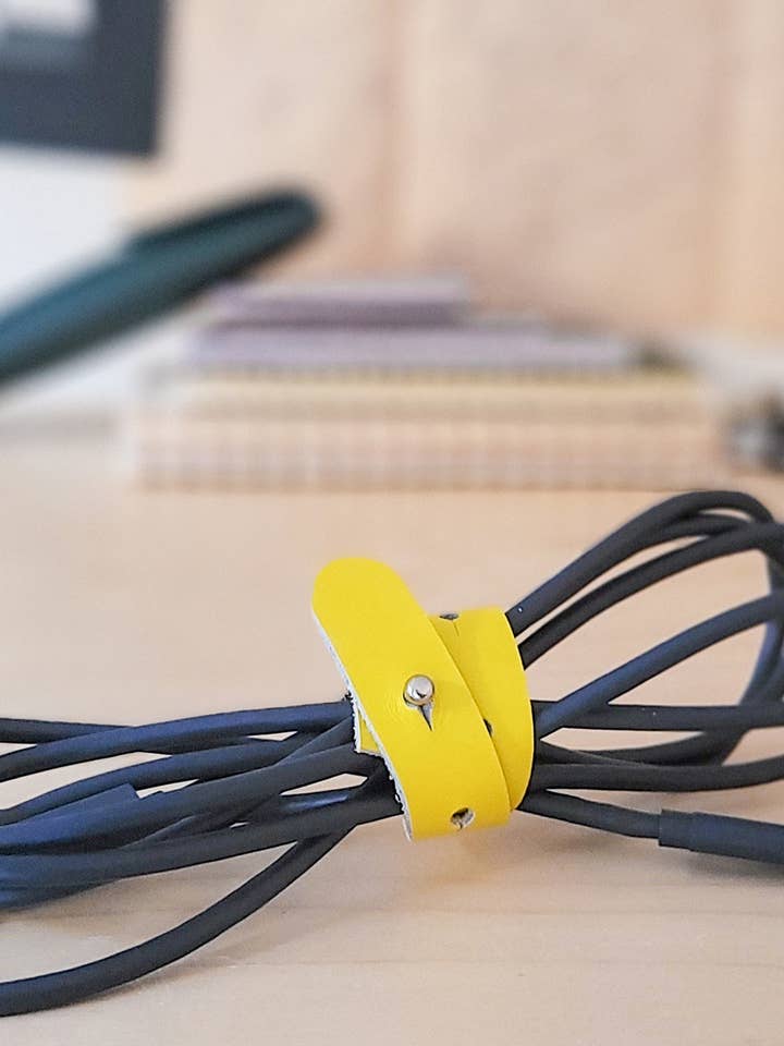 Adjustable Cord organizer in yellow, green, brown and black for wholesale by normal Behaviour