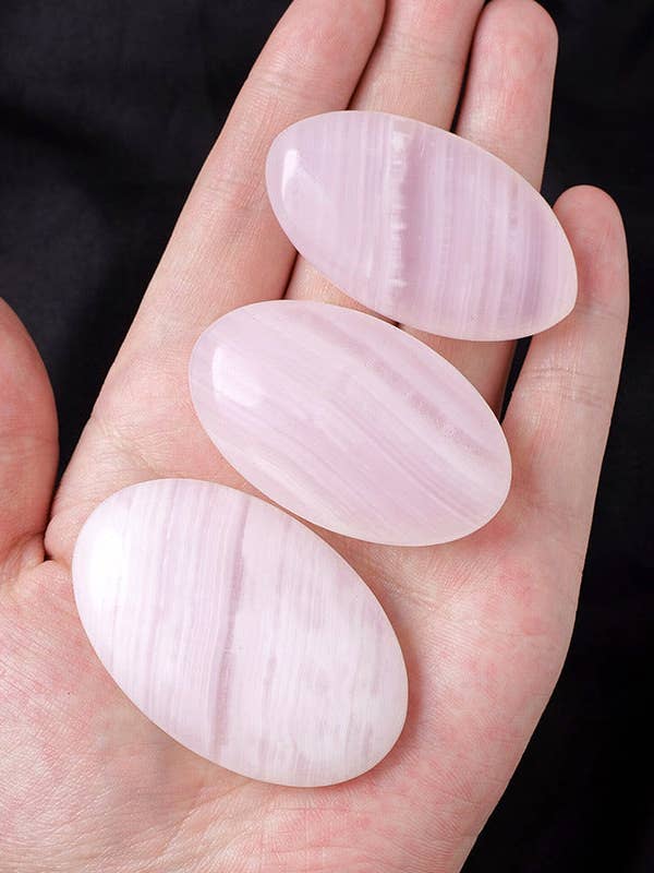 Pink Calcite Palm Stone – Peace and Compassion for wholesale by Moon Rituals