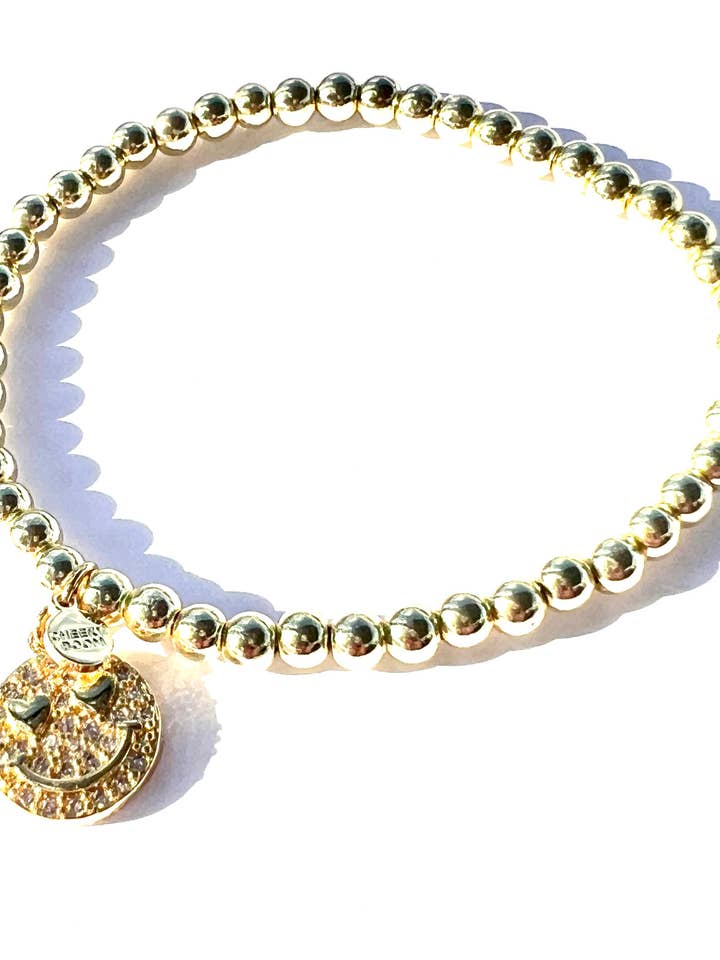 SMILE| Gold stretch bead bracelet with CZ Smile charm for wholesale by CHEEKYBOOM