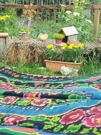 Floral handwoven green and fuchsia rug, made in wool for wholesale by MADE WITH LOVE RO SRL