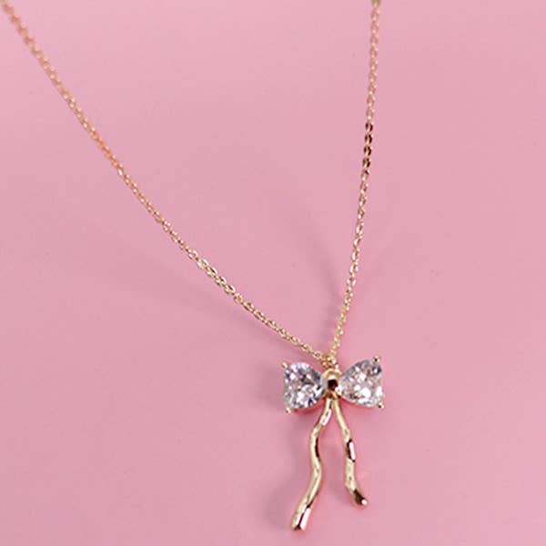 Gold PETITE RHINESTONE BOW NECKLACE | 80N600 for wholesale on Faire