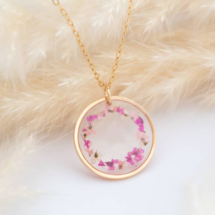 Gold round necklace with pink real flowers in resin for wholesale by Allie and Posie