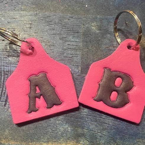 Pink Leather Initial Cow Eartag Keychain. Handmade for wholesale by AB Tack Design